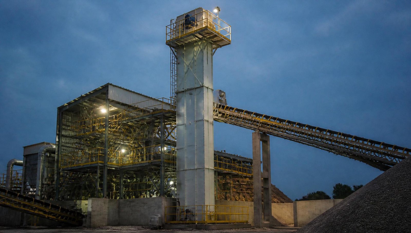 Industrial bucket elevator installed at a mineral processing plant for vertical bulk material transfer